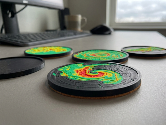 Colorful coasters with a swirling design on a desk.